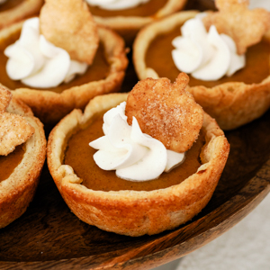 Mini pumpkin pies on a cake stand.