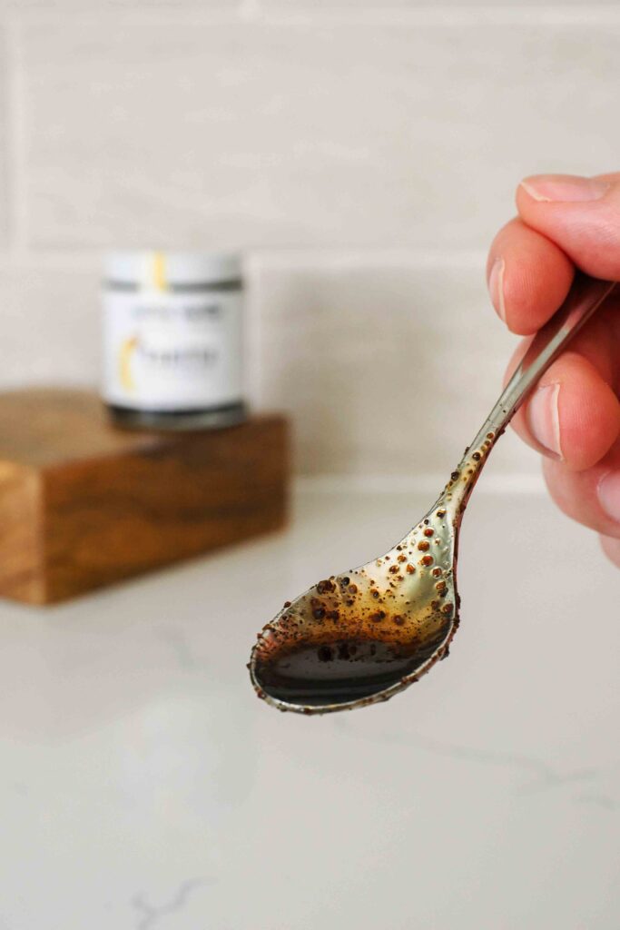 A small spoon with vanilla bean paste.