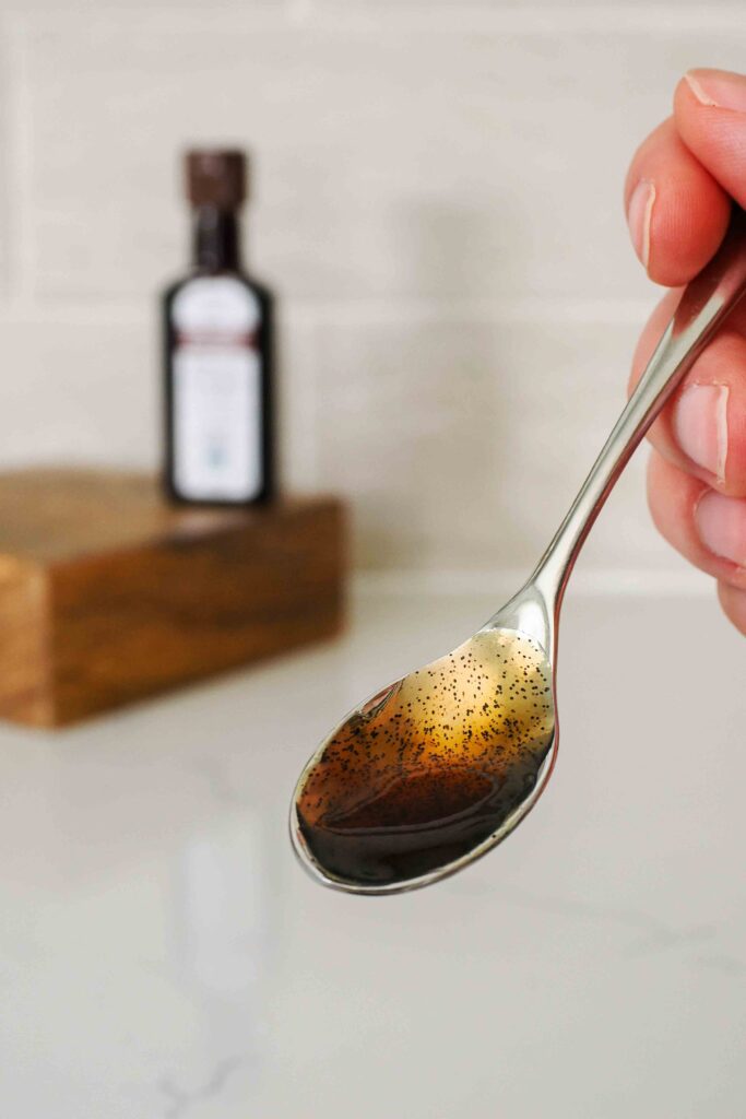 A small spoon with vanilla bean paste.