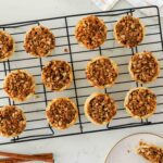 Twelve mini Dutch apple pies on a wire cooling rack.
