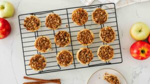 Twelve mini Dutch apple pies on a wire cooling rack.