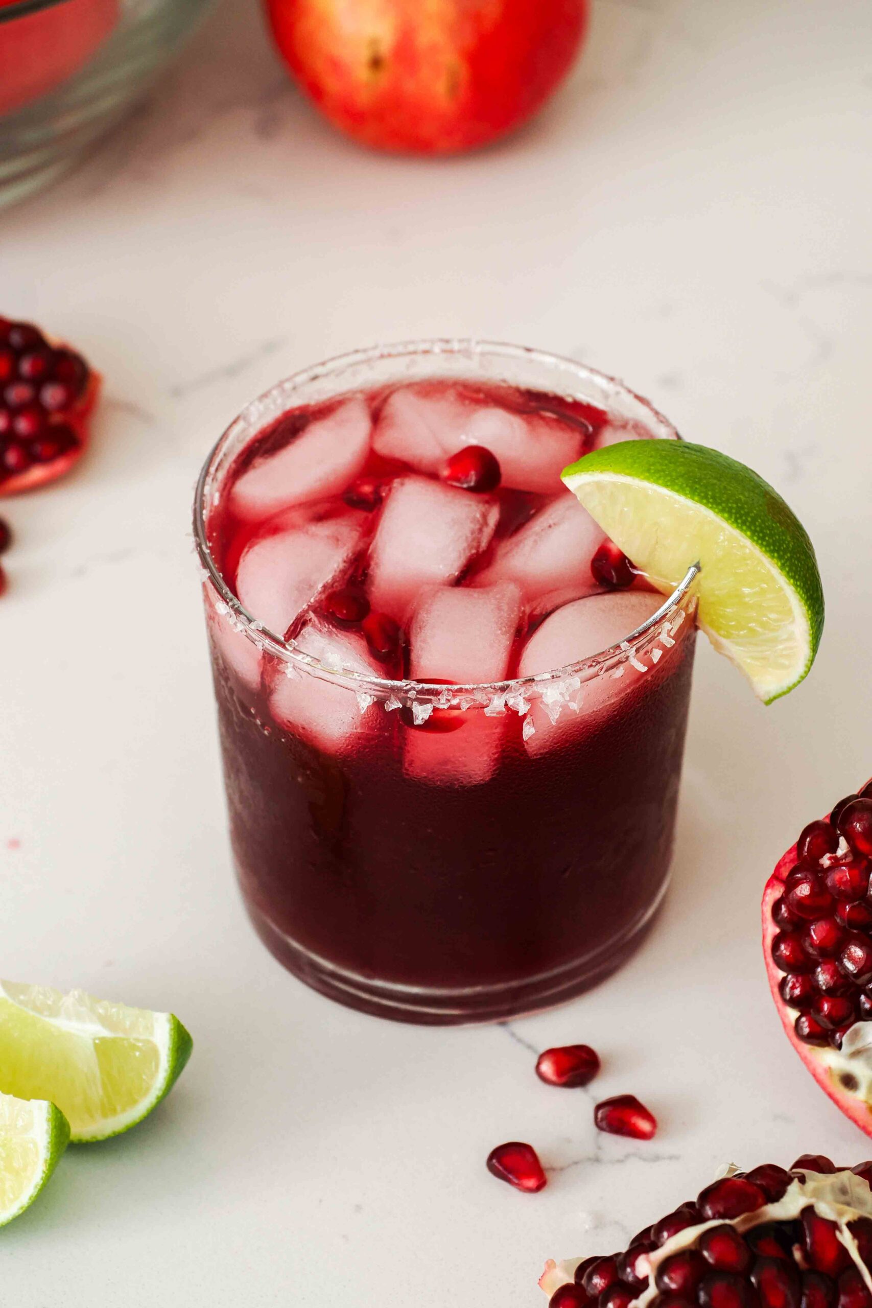 An image of a pomegranate margarita with a salt rim.