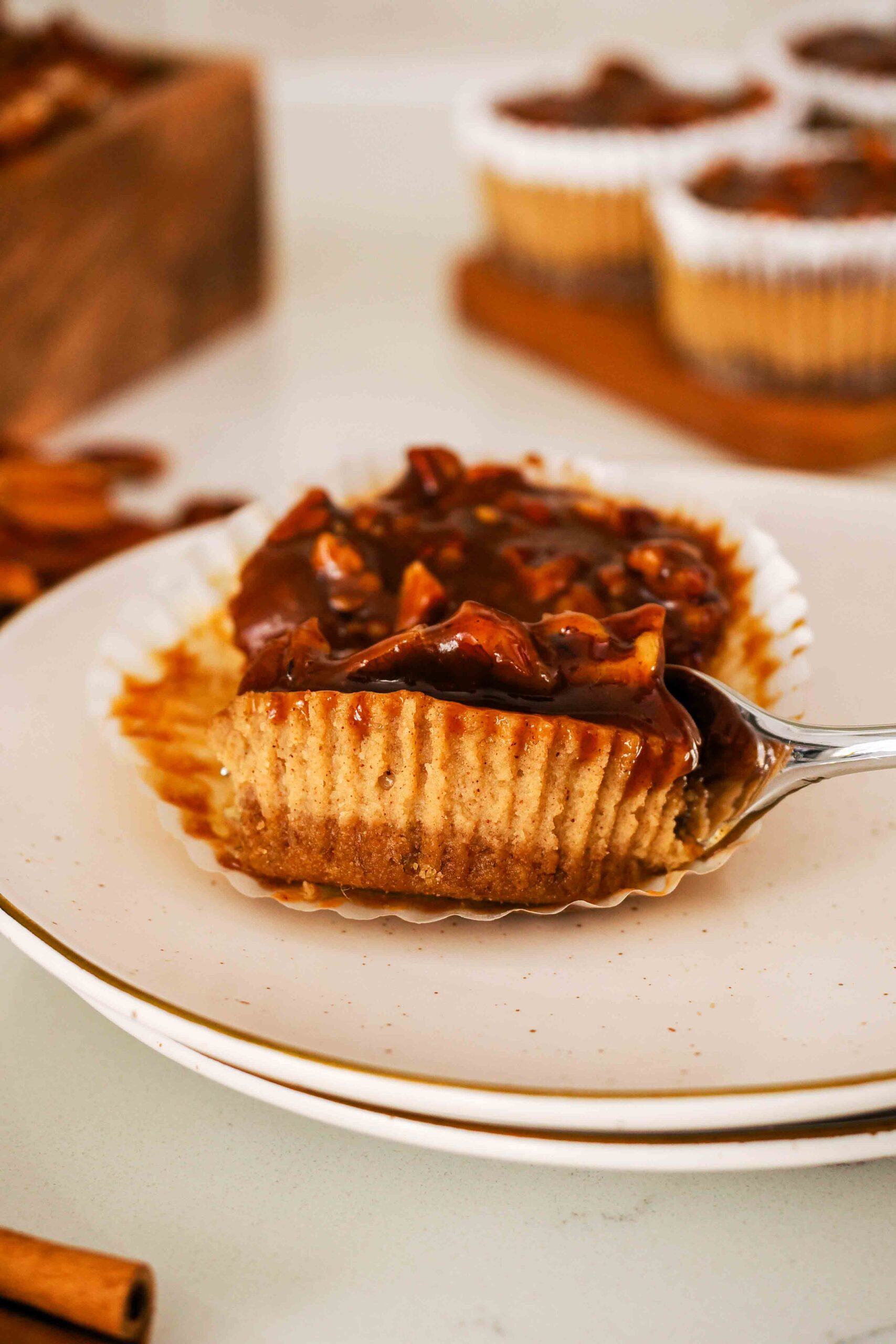 A fork cuts into a mini pecan pie cheesecake.