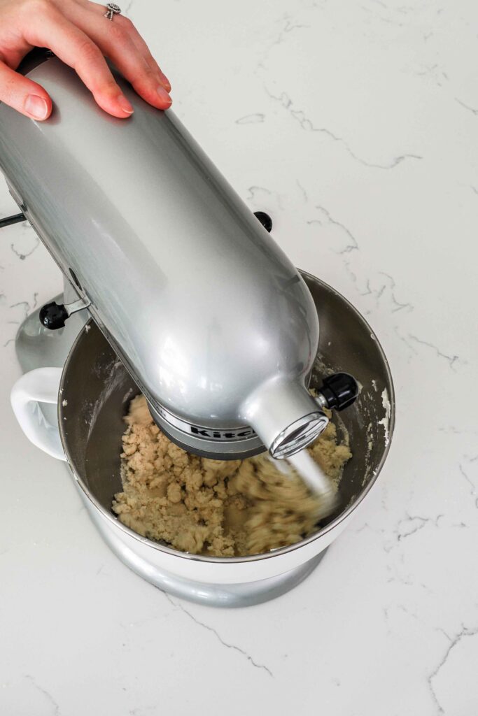 Flour is mixed into creamed butter and sugar and makes a crumbly dough.