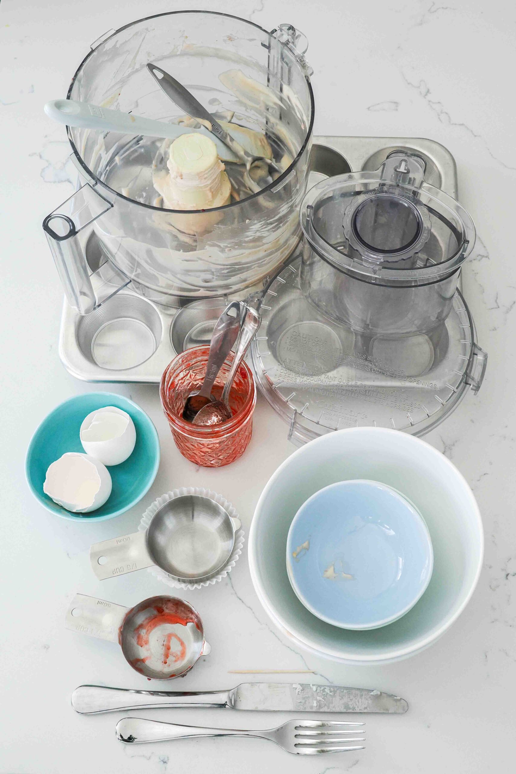 Dishes used to make mini strawberry cheesecakes.