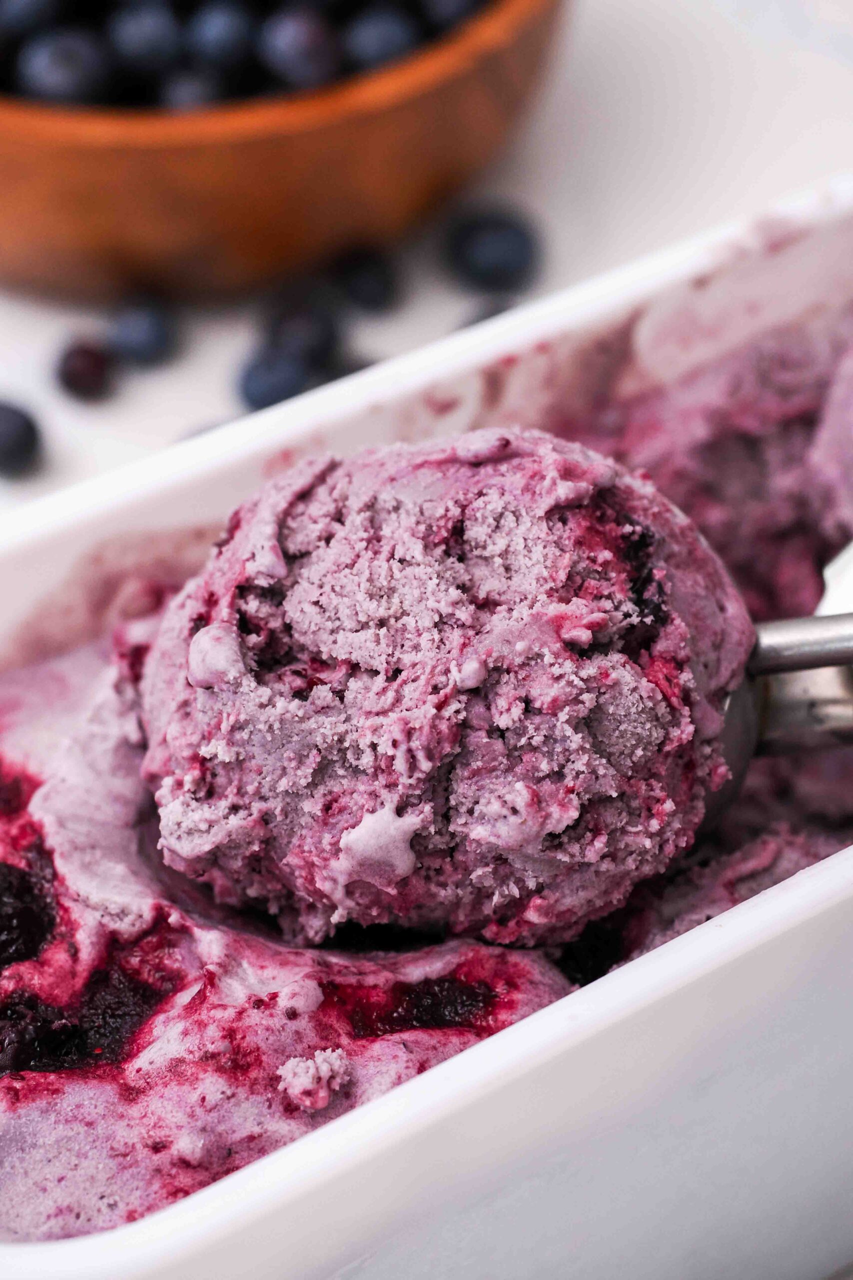 A closeup of a scoop of homemade blueberry ice cream.